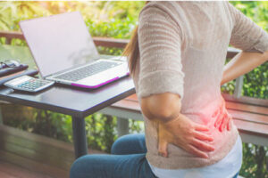 closeup-woman-with-hands-holding-her-waist-back-pain